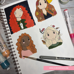 A spiral-bound sketchbook page showing four colorful illustrated portraits of women, styled with paint tubes, markers, a paintbrush, and a pen on a gray wood surface. A pink banner at the bottom reads www.