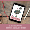 A tablet on a rustic wood surface displaying a Christmas-themed digital planner cover with a camel illustration and colorful holiday lights. A red rope, wrapped gift, and white stylus are placed around it, with a pink banner at the bottom reading 'SEASONAL DOWNLOAD: CHRISTMAS AND HOLIDAY PLANNER'.