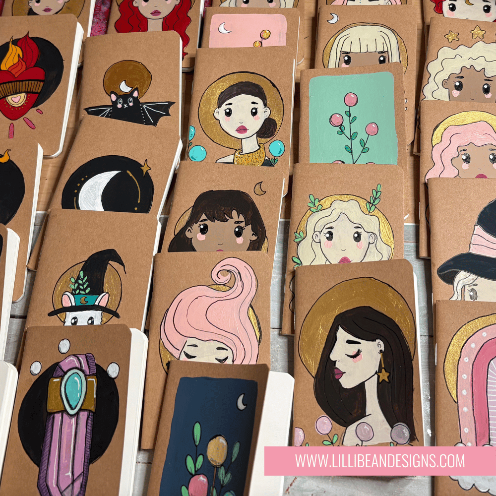 Collection of small notebooks with illustrated covers featuring various designs.