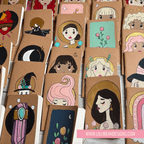 Collection of small notebooks with illustrated covers featuring various designs.