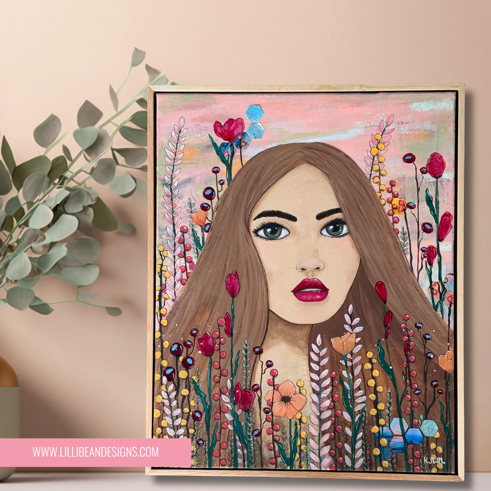 Framed artwork of a woman's face surrounded by colorful flowers on a beige wall.