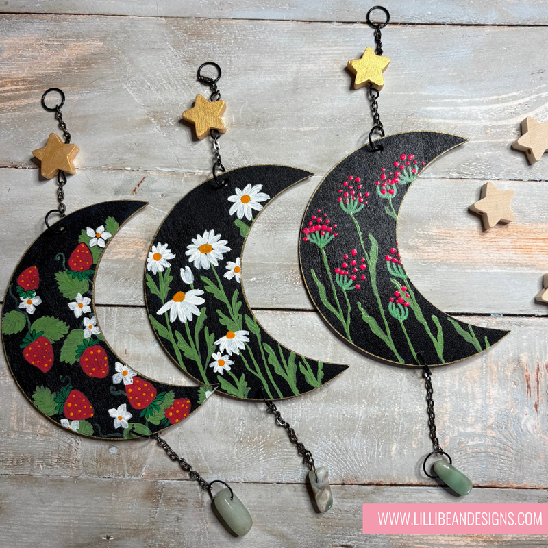 Decorative wall hangings with floral patterns on a wooden surface, featuring the brand 'LilliBean Designs'.
