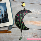 Decorative moon-shaped ornament with floral design on a wooden surface, featuring LilliBean Designs branding.