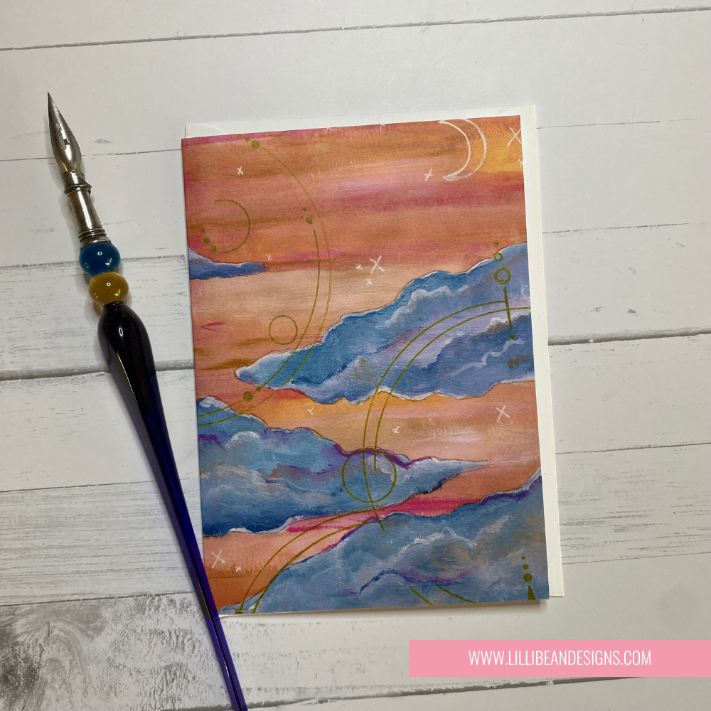 Artistic card with abstract design on a wooden surface, featuring a pen.