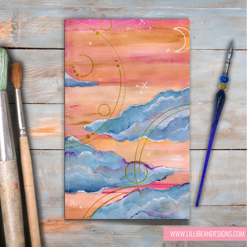 Abstract painting with pink, orange, and blue colors on a wooden surface with art tools.