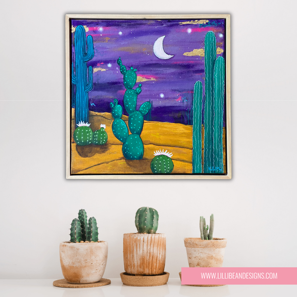 framed art work of a desert landscape in the moon light