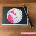 GREETING CARD with unicorn illustration on a wooden surface