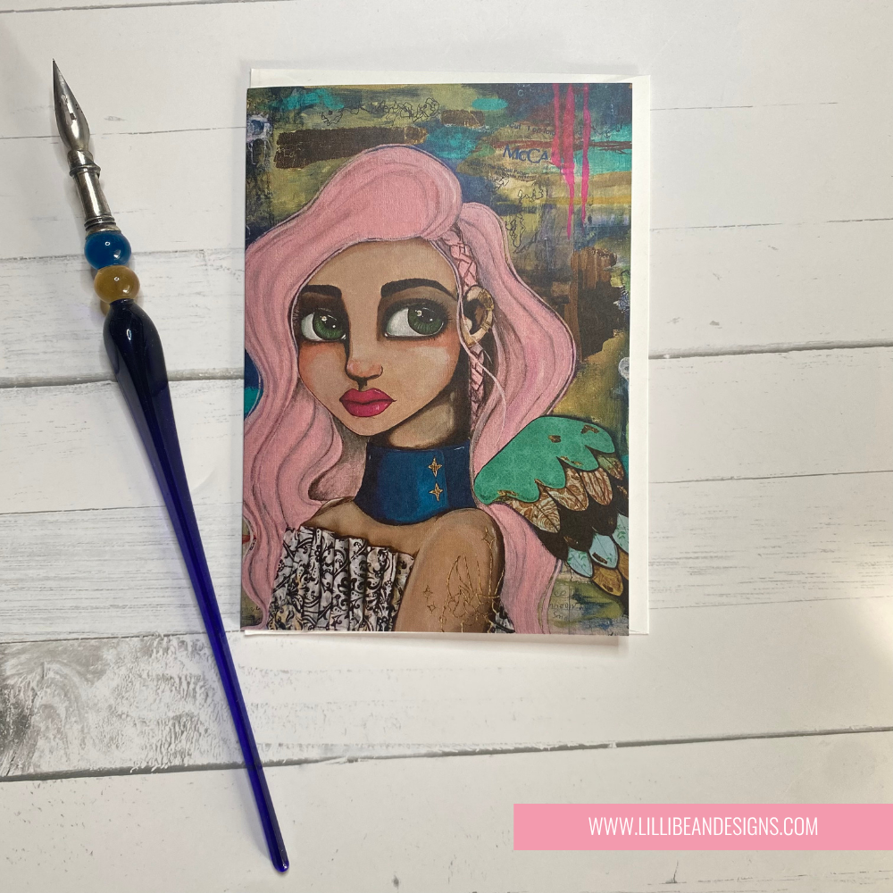 Artistic illustration of a person with pink hair and a blue necklace on a wooden surface with a paintbrush. GREETING CARD