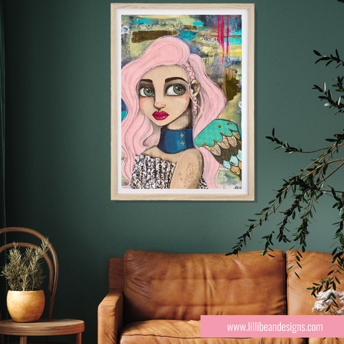 Framed artwork of a stylized woman with pink hair on a green wall above a brown leather sofa.