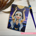 Illustration of a woman holding the moon on a card with a pen and plant in the background.