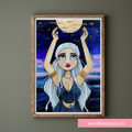 Framed artwork of a woman holding the moon against a starry night sky.