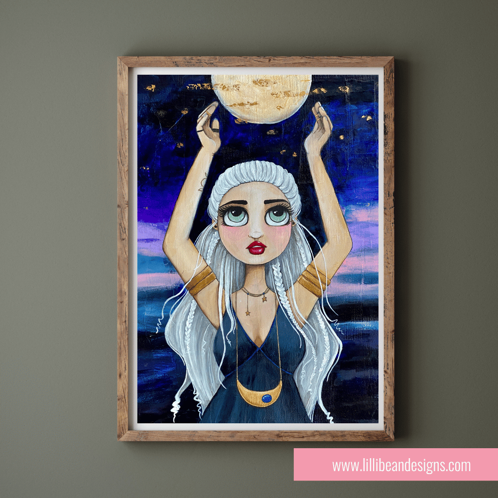 Framed artwork of a woman holding the moon against a starry night sky.