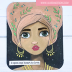 Illustration of a woman with green eyes and pink hair, wearing gold hoop earrings, on a white background with text 'I open my heart to love.'.