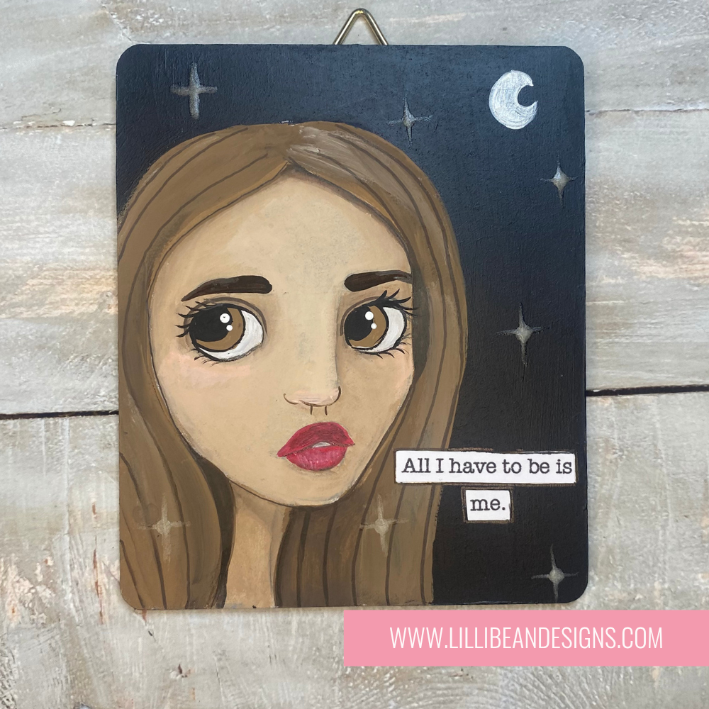 Artistic depiction of a woman's face with a motivational quote on a wooden background, featuring the artist's website.