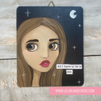 Artistic depiction of a woman's face with a motivational quote on a wooden background, featuring the artist's website.