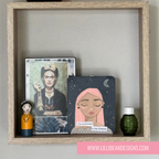 a decorative shelf with soul mantra, frieda and a wee beastie