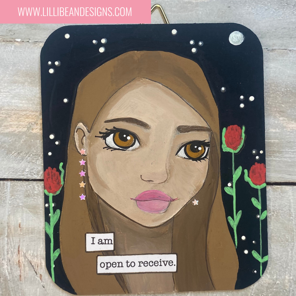 Artistic depiction of a woman's face with a motivational quote on a wooden background, featuring the artist's website.
