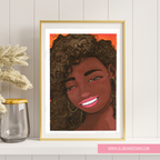 Framed artwork of a woman with curly hair on a wall with a vase and plant.