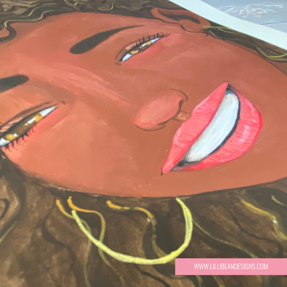 Framed artwork of a woman with curly hair and a big smile