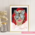 Framed artwork of a woman with red hair and a butterfly on her face, displayed on a wall.