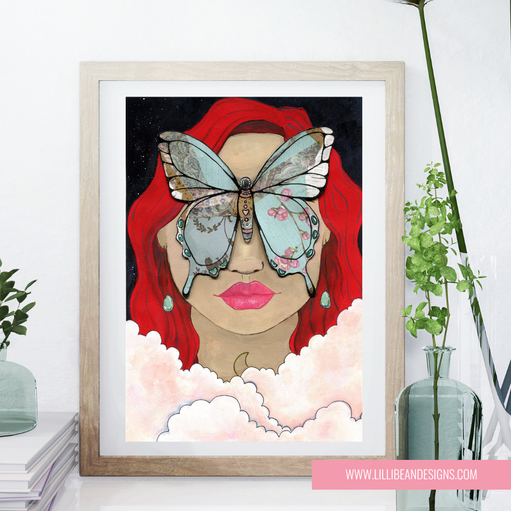 Framed artwork of a woman with red hair and a butterfly on her face, on a white wall