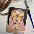 Illustration of a person with a butterfly on their face, surrounded by clouds and a starry sky, with LillieBean Designs branding. GREETING CARD