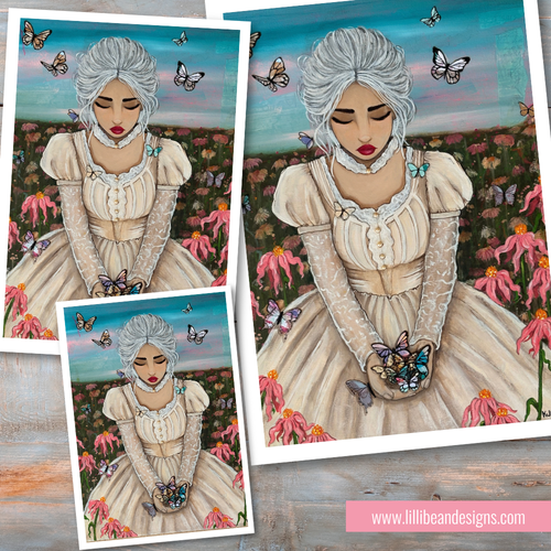 Three art prints featuring a Victorian-style illustration of a young woman with white hair in a cream dress, holding a butterfly, set against a field of pink flowers and blue sky, displayed on a rustic wood background.