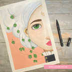 A flat-lay photograph of an art print featuring a stylized portrait of a woman with white hair, green eyes, and pink lips, decorated with green ivy vines. The print is displayed on a rustic gray wooden table alongside a black marker and a black pen cap, with a pink brand label at the bottom right reading 'WWW.