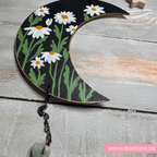 Decorative half-moon wall hanging with floral design on a wooden surface, featuring the brand 'LilliBean Designs'.