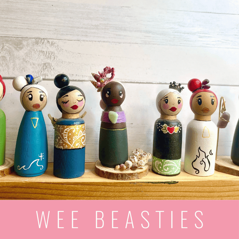 Set of colorful wooden figurines with 'WEE BEASTIES' branding on a wooden shelf. LilliBean Designs