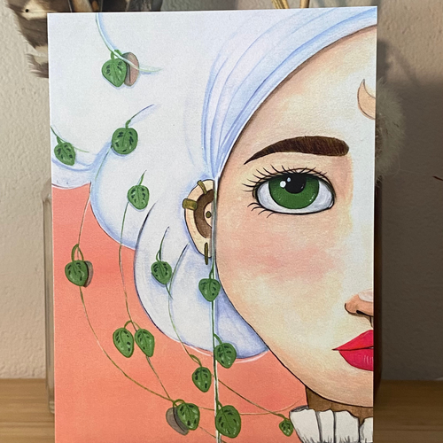 Illustration of a woman's face with green eyes  surrounded by green leaves on a peach background.