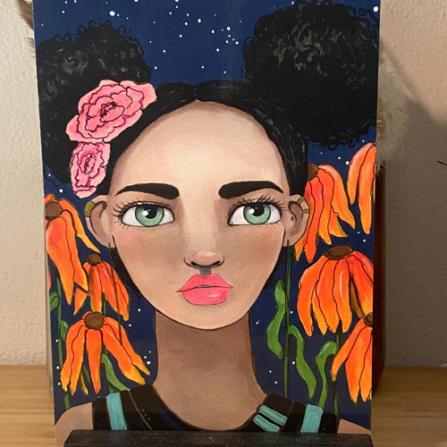 Painting of a woman's face with flowers on a dark blue background