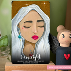 Artistic depiction of a woman with gray hair and pink lipstick, accompanied by a small figurine.