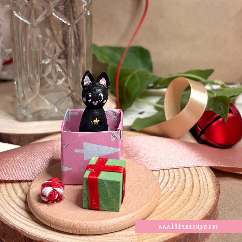 Black cat in present handpainted wooden doll