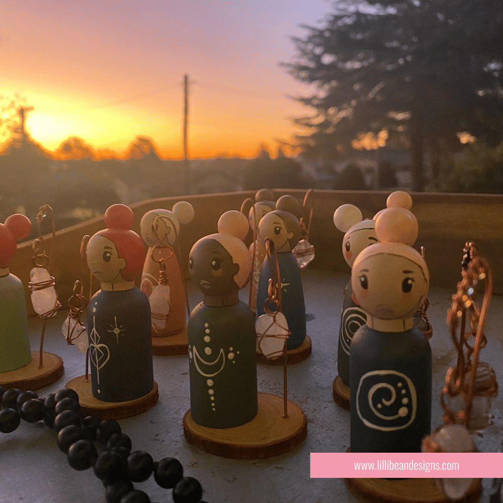 Collection of small figurines with a sunset background