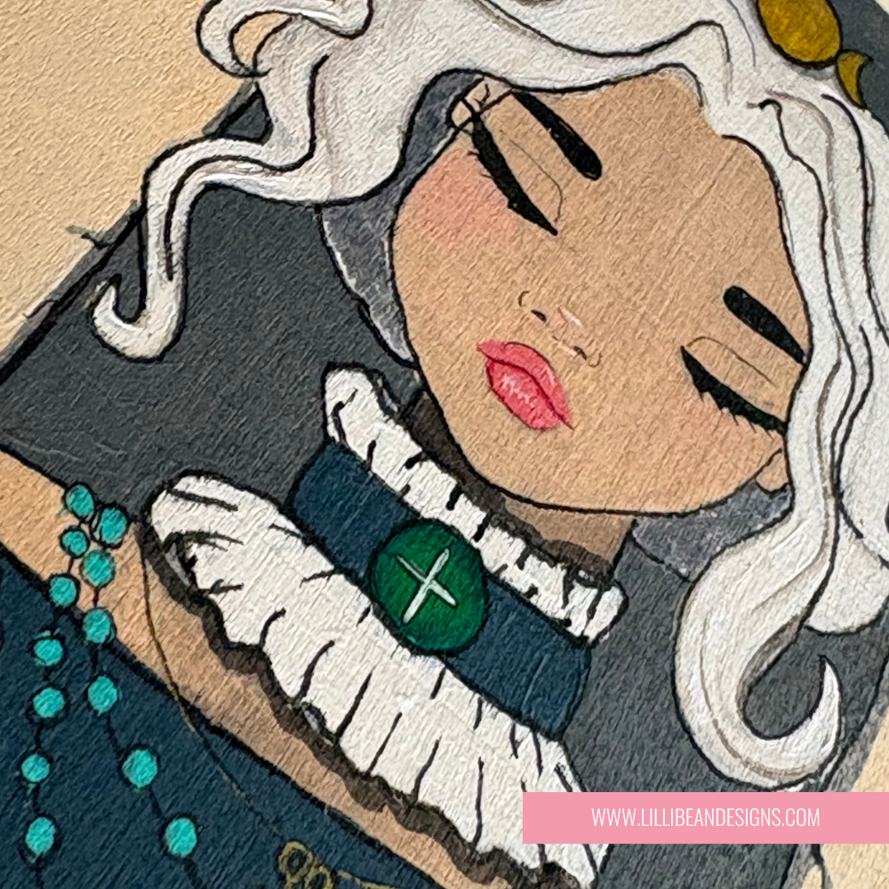 Artistic illustration of a woman with white hair and a green brooch, featuring LillieBean Designs logo.