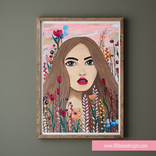 Framed artwork of a woman's face surrounded by flowers on a gray wall.