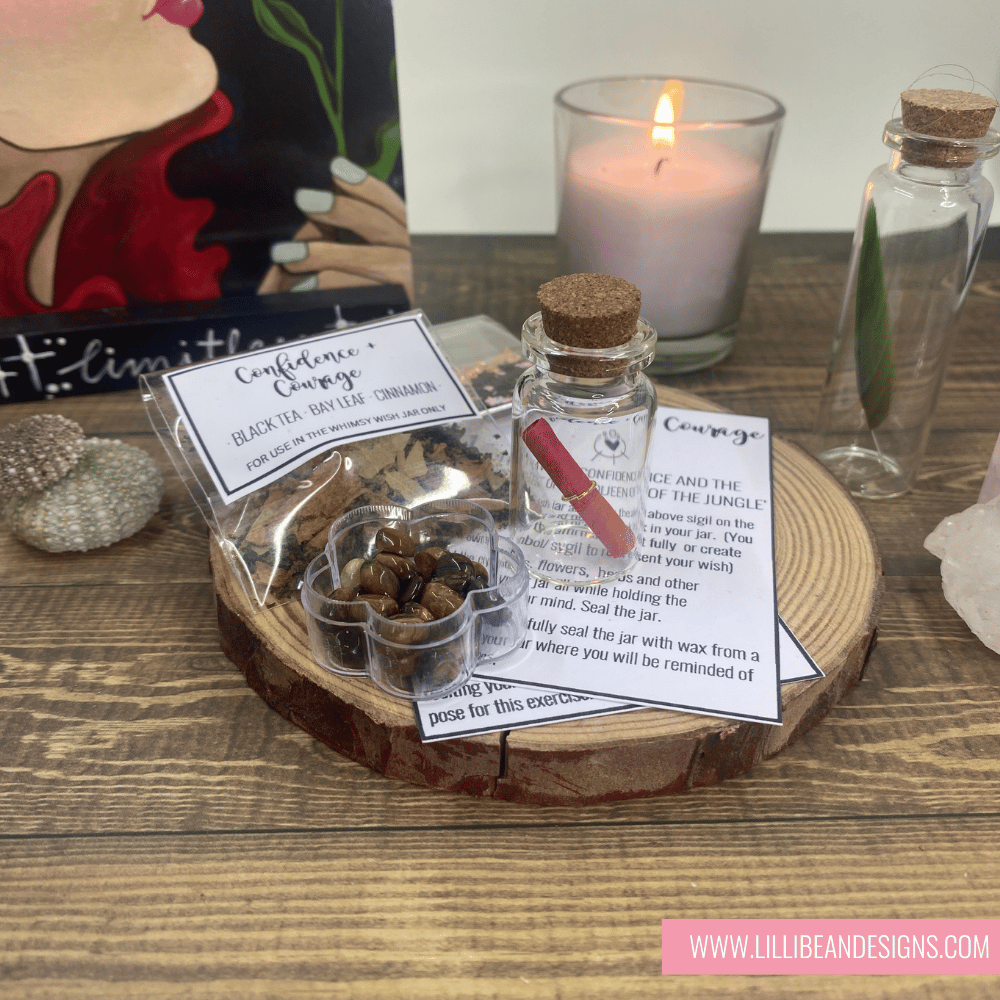 Small glass jar with cork lid on a wooden surface with candles and decorative items. MAGICAL WISH KIT