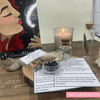 Decorative items including a candle, small bottles, and a painting on a wooden surface.
