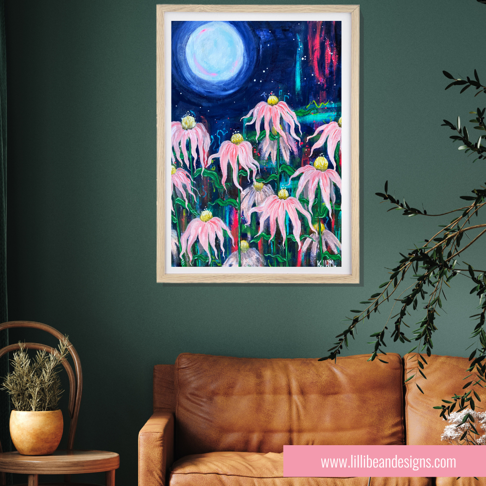 Framed artwork of pink flowers under a night sky on a green wall above a brown sofa.