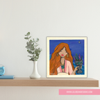 Framed illustration of a woman with red hair on a shelf with decorative items.