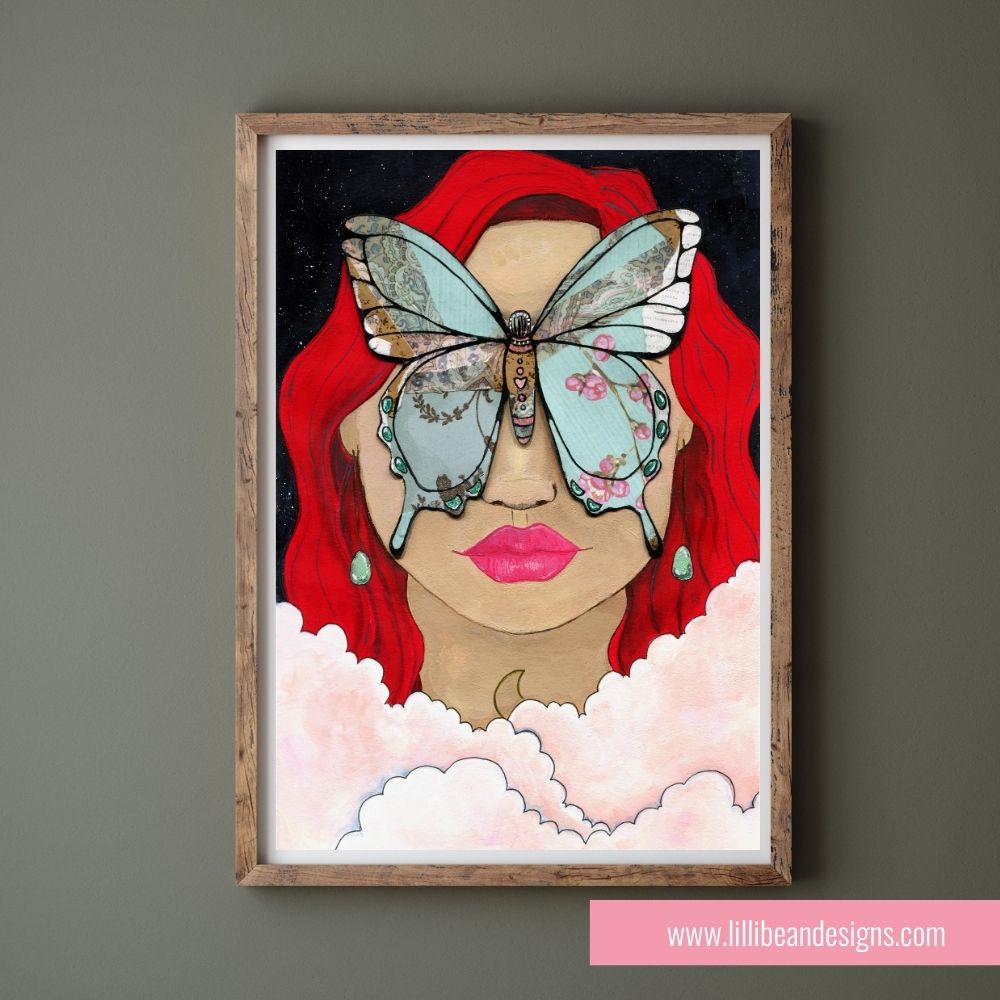 Framed artwork of a woman with red hair and a butterfly on her face against a dark background.