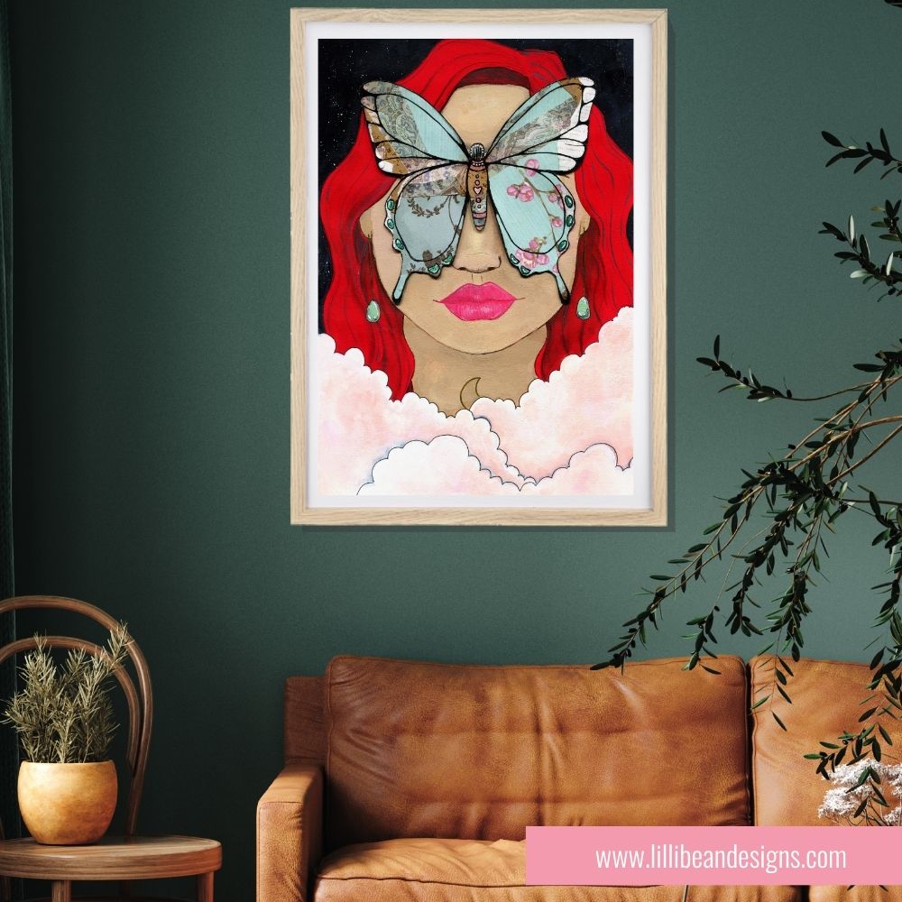 Framed artwork of a woman with red hair and a butterfly on her face, hanging on a green wall above a brown leather sofa.
