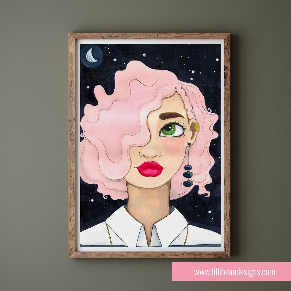 Framed artwork of a person with pink hair and green eyes on a dark background, displayed on a wall.