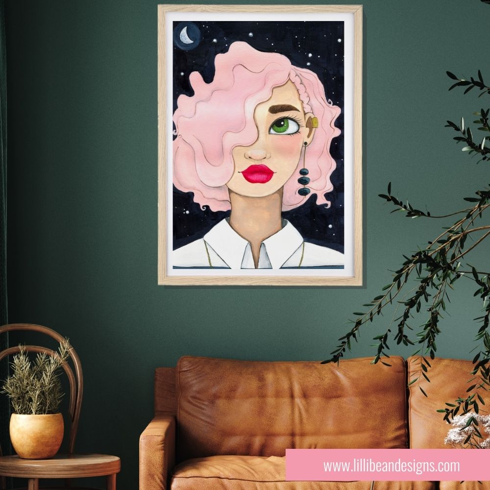 Framed artwork of a woman with pink hair on a green wall above a brown sofa.